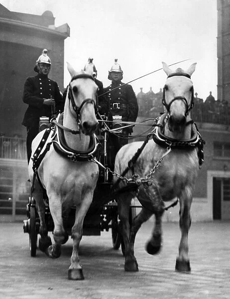 Horse-drawn fire vehicle and crew in display