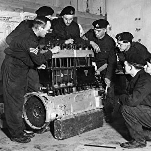 A sectionised old bus engine is used to teach these members of a West Country Tank Corps