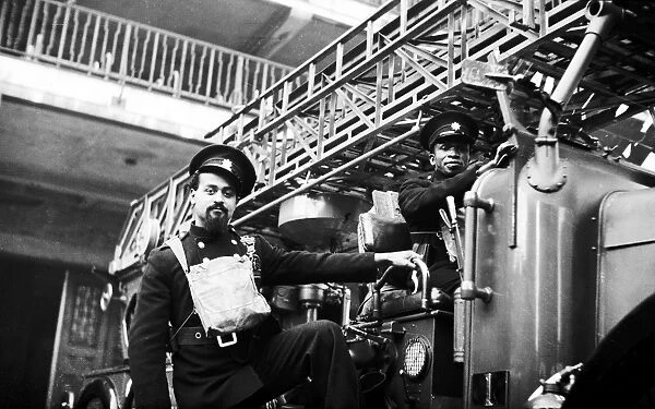 Two AFS firefighters with turntable ladder, WW2