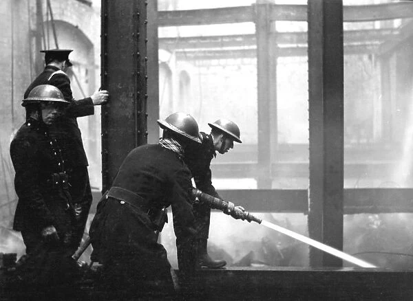 Blitz in London - Firefighters at work with hosepipe, WW2