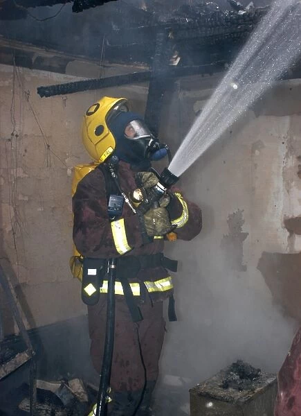 Firefighter in breathing apparatus working at fire