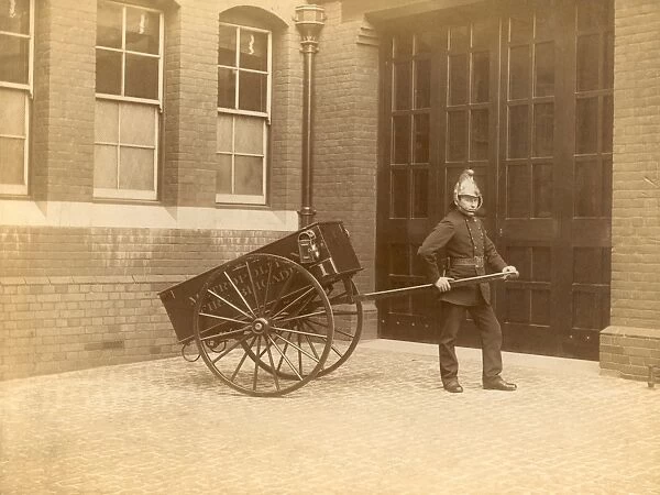 A firefighter of the London Fire Brigade pulling a cart