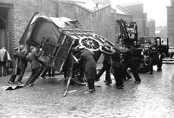 Firefighters attempt to right a fallen cart, WW2
