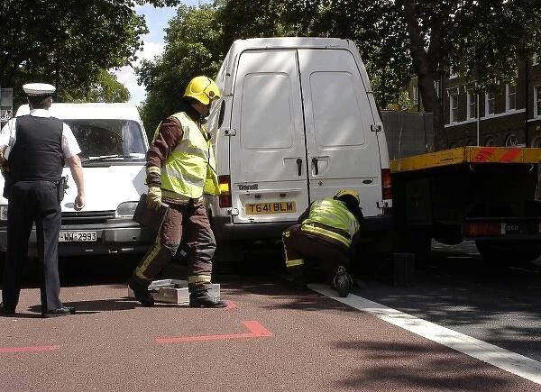 Firefighters inspecting a broken down Ford transit van