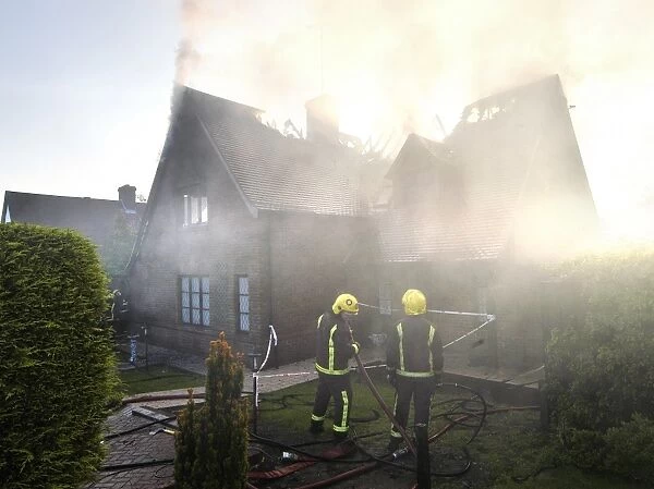 Firefighters working at scene of domestic fire, Harrow