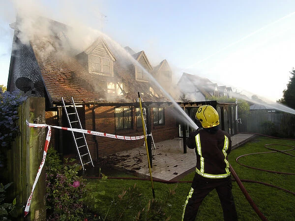 Firefighters working at scene of domestic fire, Harrow