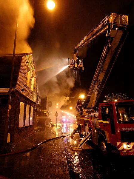 Firefighters working at scene of pub fire, SE London