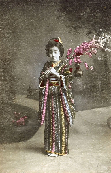 Japan - Young Japanese Girl holding cherry blossom frond