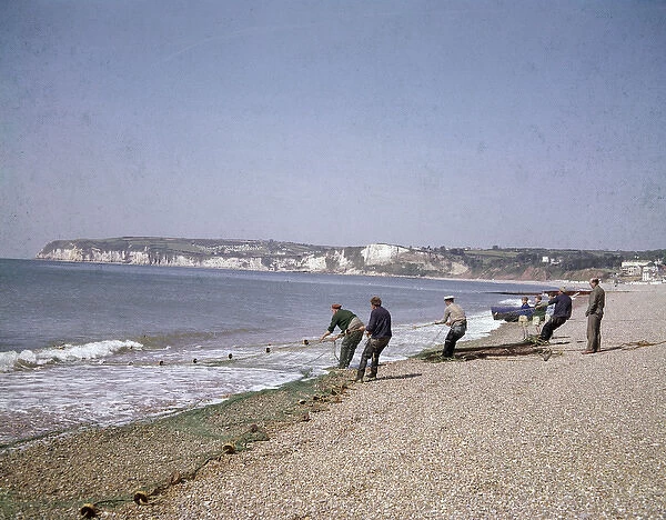 Men with fishing nets at Seaton, Devon