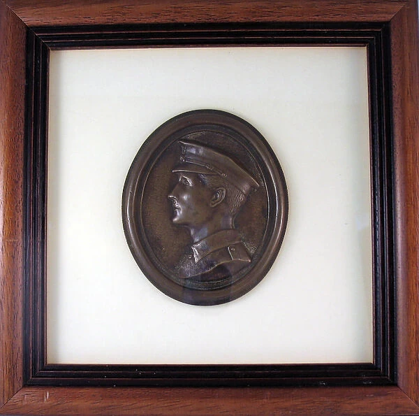 Oval plaque in relief depicting the head of a young Tommy