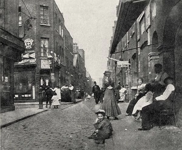 People sitting on street, Whitechapel, East London