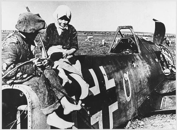 Soviet peasants inspect a shot-down Messerschmidt ME 109 BF