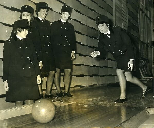 Women police officers at a bowling alley