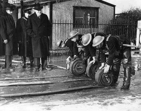 AFS firefighters unrolling hosepipes, WW2