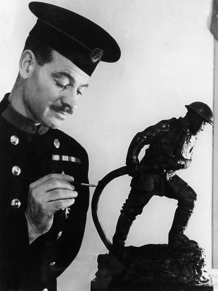 Firefighter painting statuette of fireman in action