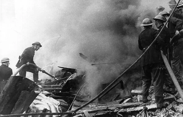 Firefighters in action after air raid, WW2