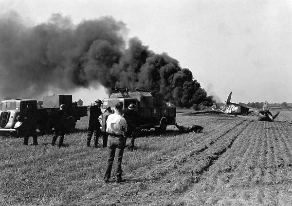 Firefighters attending crashed plane in field, WW2