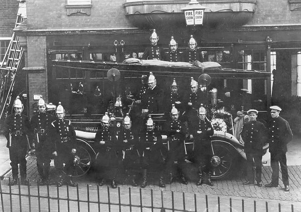 Firefighters and fire engine posing outside station