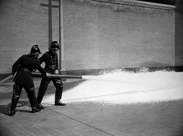 Firefighters training with foam extinguisher