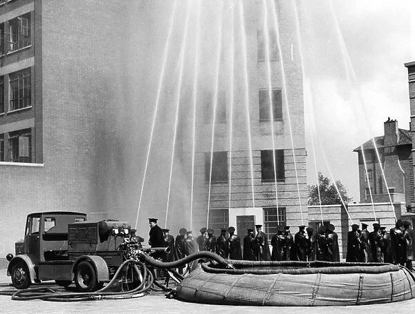London firefighters with hosepipes