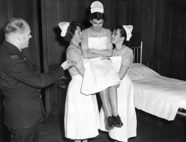 Student nurses practising three handed lift