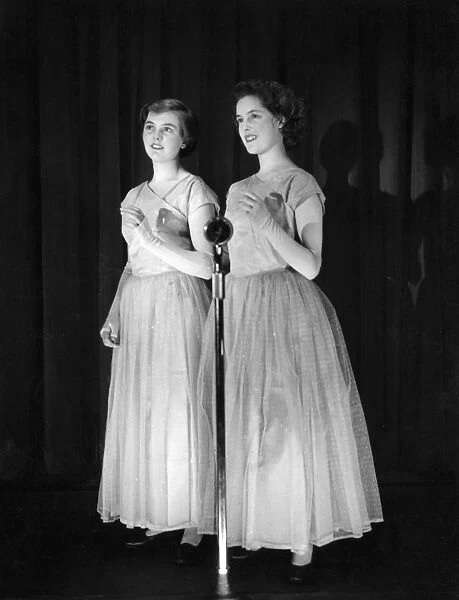 Two young women performing on stage