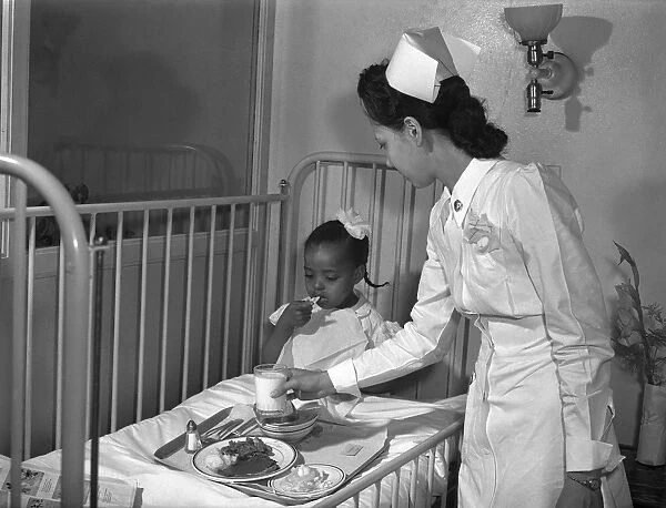 CHICAGO: HOSPITAL, 1942. A nurse serving lunch in the childrens ward at Provident Hospital