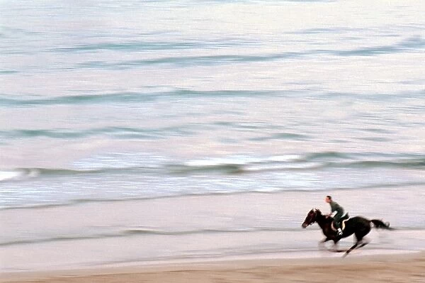 One Man Riding Horse on the Beach