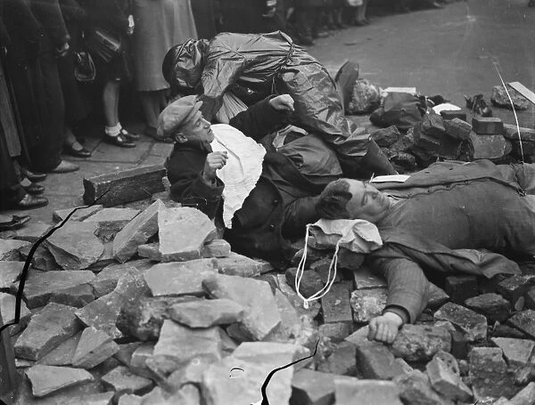 Air Raid Precaution exercise on Old Kent Road in London. Spectators look on as the