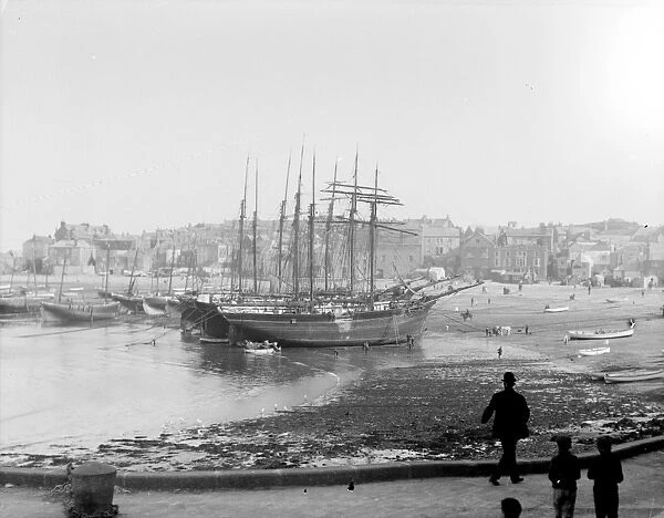 Three schooners beached in the harbour at low tide, St Ives, Cornwall. Early 1900s