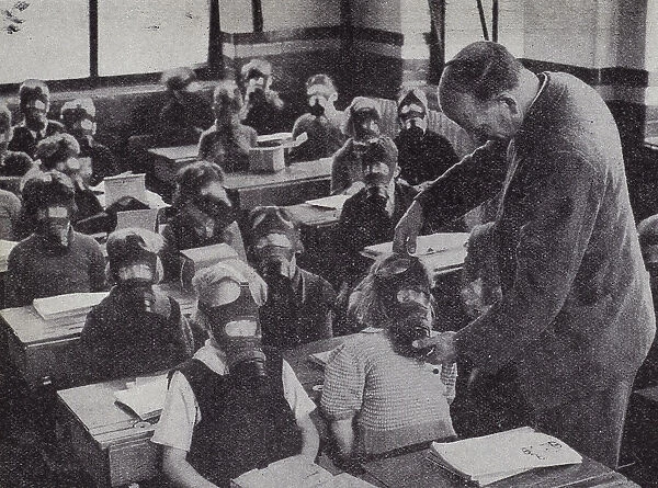 British schoolchildren practicing putting on their gas masks, World War II, 1939-1945 (b  /  w photo)