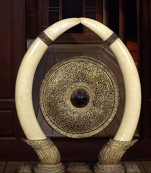 A gong hanging from elephant tusks (metal & ivory)