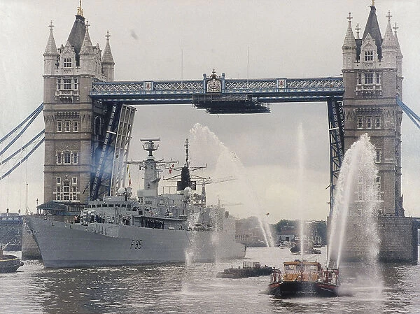 View of HMS London sailing beneath Tower Bridge, London, 1988