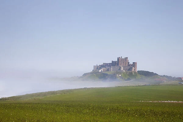 Bamburgh Castle On A Hill In The Fog; Northumberland England