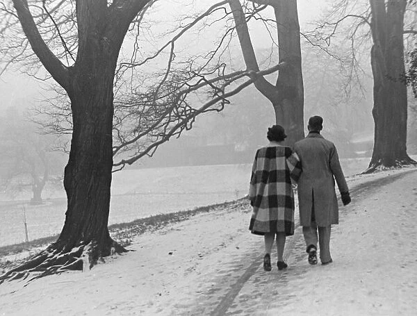 A couple walking in a snowy Regents Park London January 1942