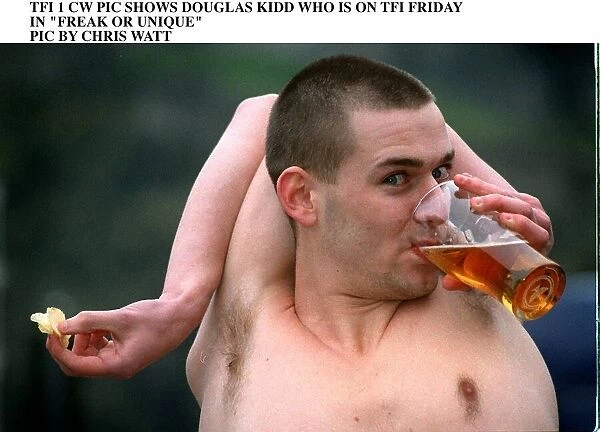 Douglas Kidd drinking glass pint of lager with his arm bent around the back of his head