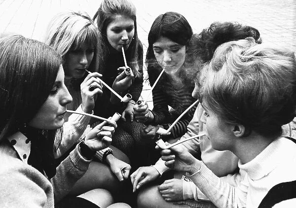 Female students smoke pipes for a contest in 1969