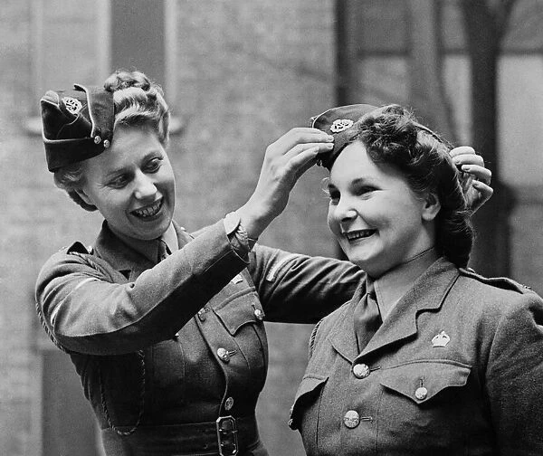 Members of the ATS adjust their caps before a parade. March 1944 P010241