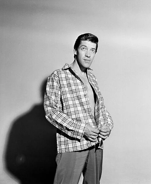Singer Michael Holliday poses wearing check shirt. 24th November 1957