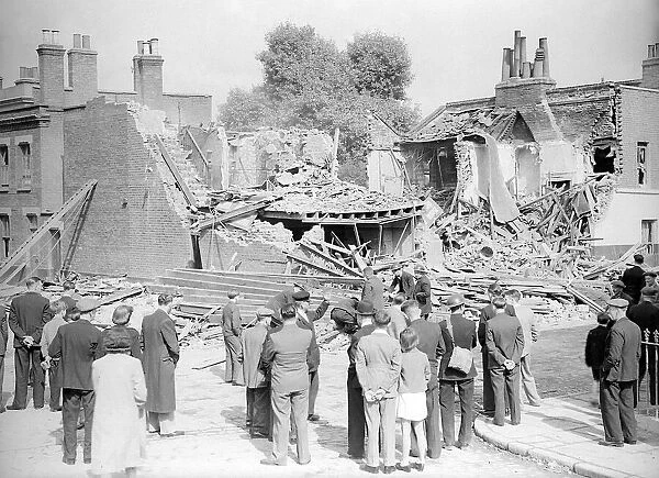WW2 The Blitz Bomb damage in London Local residents stop to look at bomb