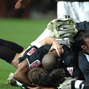 Lee Johnsons team mates pile on top to join the celebrations