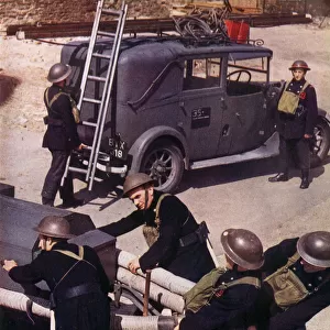 Auxiliary Fire Service (A. F. S. ) Men hauling the Trailer-pump