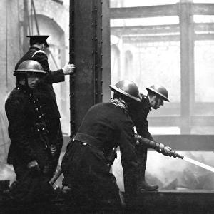 Blitz in London - Firefighters at work with hosepipe, WW2