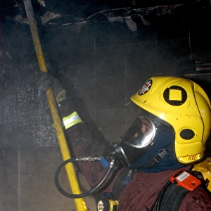 Firefighter in breathing apparatus working at fire