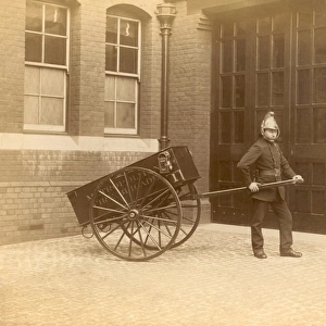 A firefighter of the London Fire Brigade pulling a cart