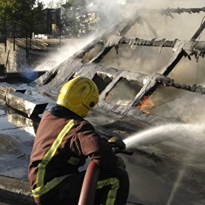 Firefighter working at scene of fire, New Cross