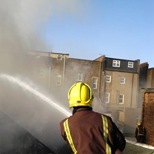 Firefighter working at scene of fire at New Cross