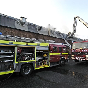 Firefighters in a hydraulic lift at a fire on West Road