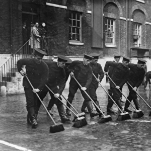 Firefighters with sweeping brushes, Southwark HQ