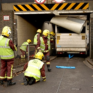 Firefighters working to remove van trapped under bridge